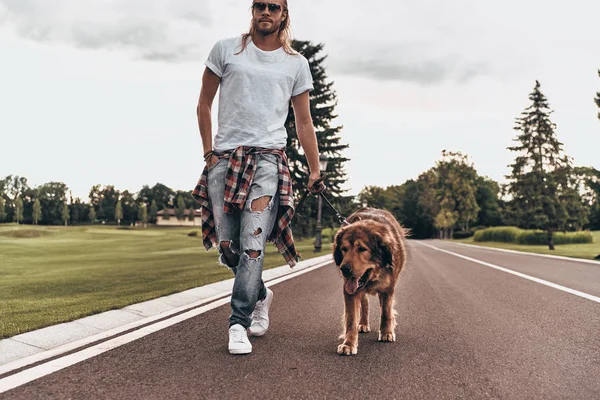 handsome man walking with dog