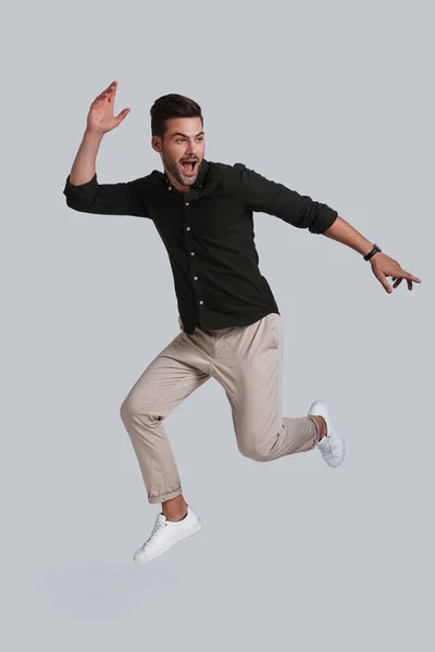 Handsome young man jumping — Stock Photo, Image