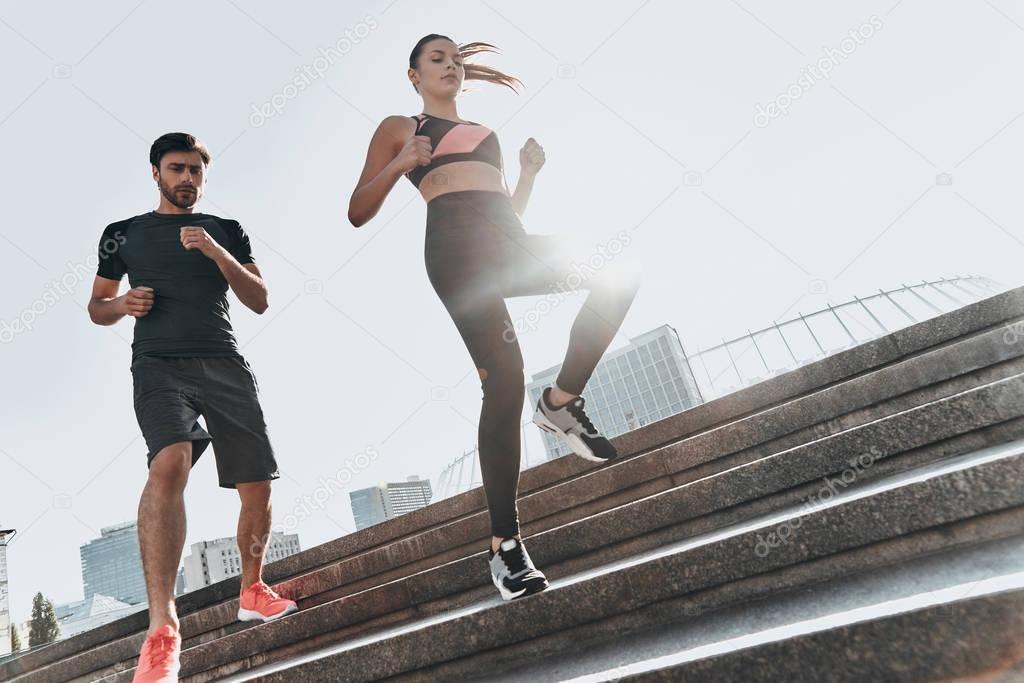 sportive couple running down the stairs