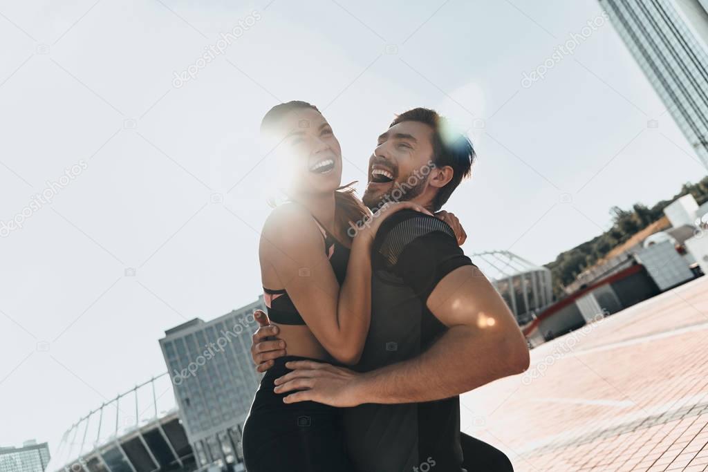 Handsome man carrying attractive woman 