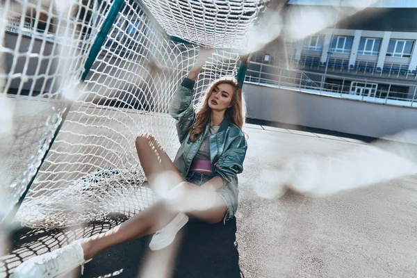 Blonde woman in sportive clothing sitting — Stock Photo, Image