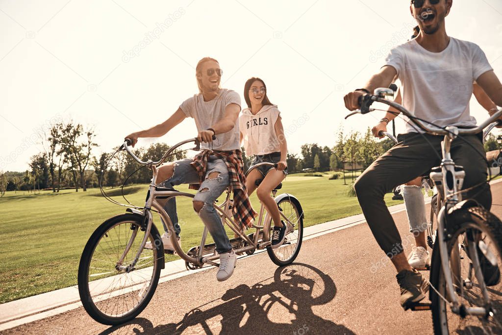 friends riding tandem bicycles