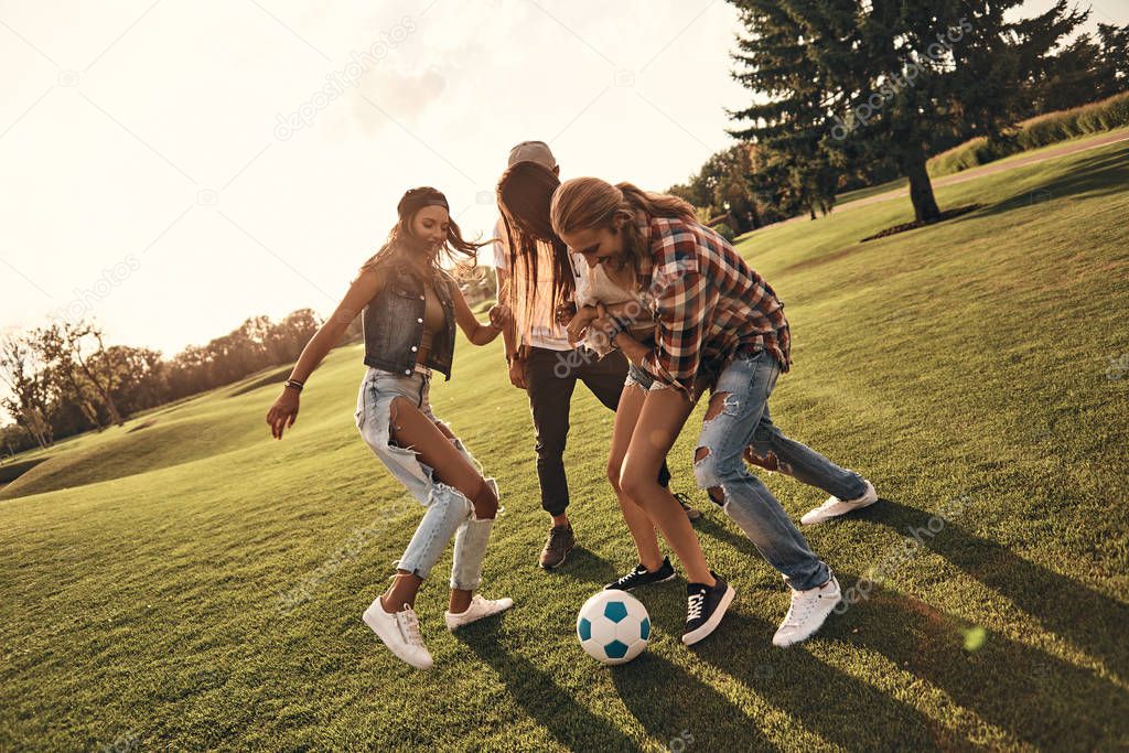 four friends playing soccer