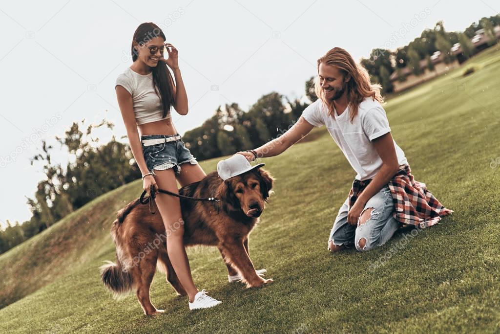 couple having fun with big dog 