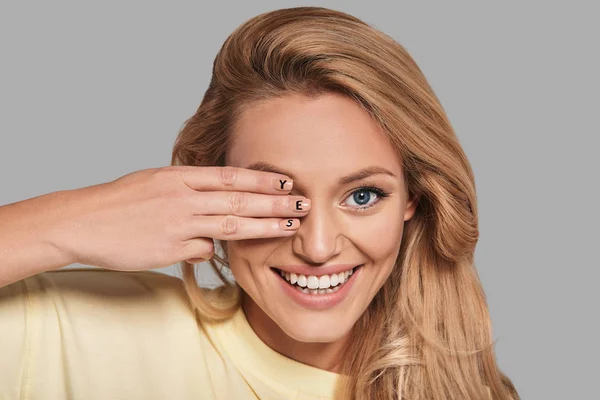 Woman covering eye with hand — Stock Photo, Image