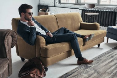 businessman relaxing on sofa 