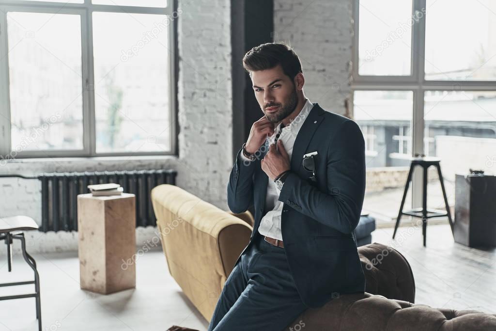 thoughtful handsome young businessman in suit 