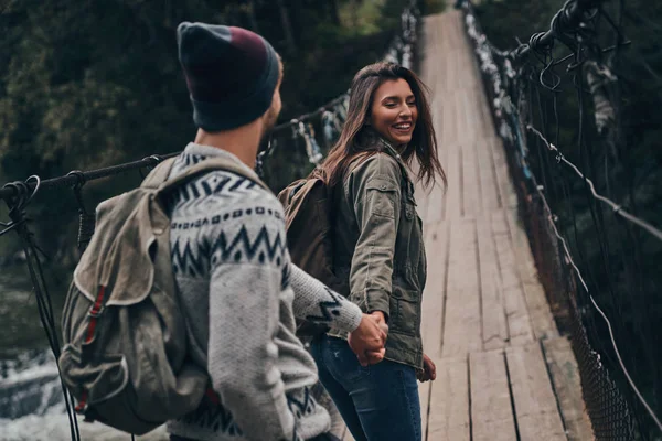 Pareja caminando en puente colgante —  Fotos de Stock