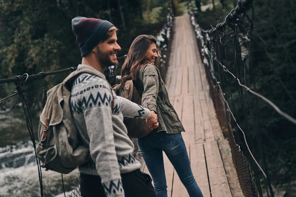 Paar läuft auf Hängebrücke — Stockfoto