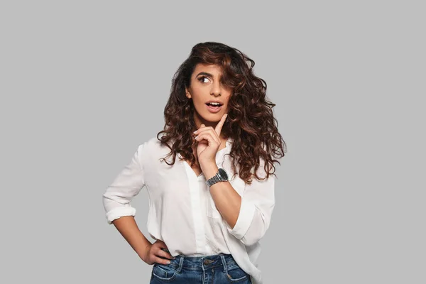 Thoughtful Woman Curly Hair Posing Studio Holding Finger Chin — Stock Photo, Image