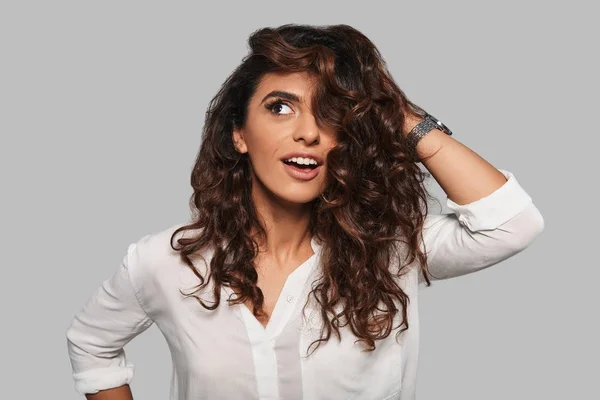 Playful Brunette Woman Posing Studio Touching Her Curly Hair — Stock Photo, Image