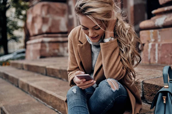Attractive Blonde Young Woman Using Smart Phone While Sitting Outdoors — Stock Photo, Image