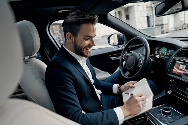 Handsome Young Man Suit Writing Notes Personal Organizer While Sitting — Stock Photo, Image