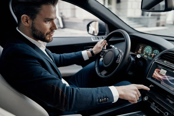 Handsome Young Man Suit Pushing Buttons While Driving Car — Stock Photo, Image