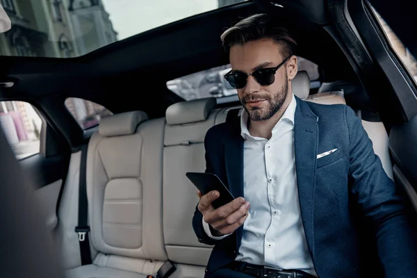 Handsome Young Man Suit Looking His Smart Phone While Sitting — Stock Photo, Image