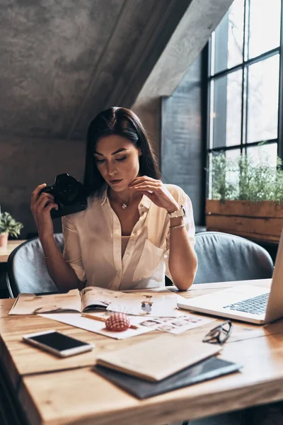 Schöne Junge Frau Schaut Modezeitschrift Und Hält Digitalkamera Während Sie — Stockfoto