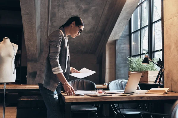 Concentrated Young Woman Eyewear Looking Sketches While Leaning Desk Her — Stock Photo, Image