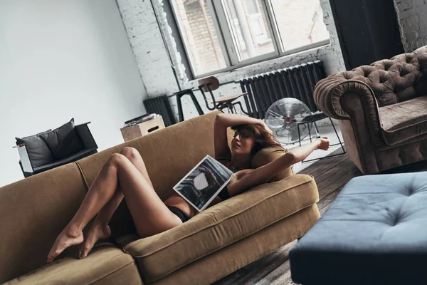 Gorgeous Woman Covered Magazine Lying Sofa Home — Stock Photo, Image