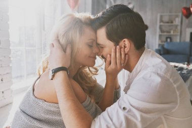close up portrait of passionate young couple in love bonding and smiling