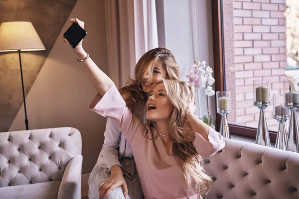 Beautiful Blonde Women Elegant Dresses Taking Selfie Smiling While Sitting — Stock Photo, Image