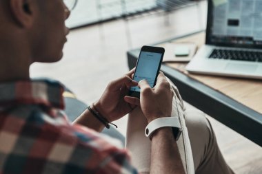 Kısmi tipik haber akıllı telefon kullanan akıllı casual adam görünümünü