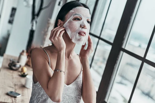 Brunette Young Woman Applying Facial Mask While Spending Time Home — Stock Photo, Image