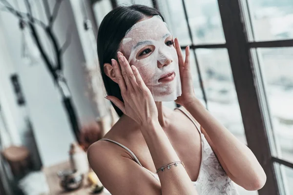 Brunette Young Woman Applying Facial Mask While Spending Time Home — Stock Photo, Image