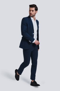 tam takım gri arka planı yürüyüş yakışıklı genç adam tam uzunlukta