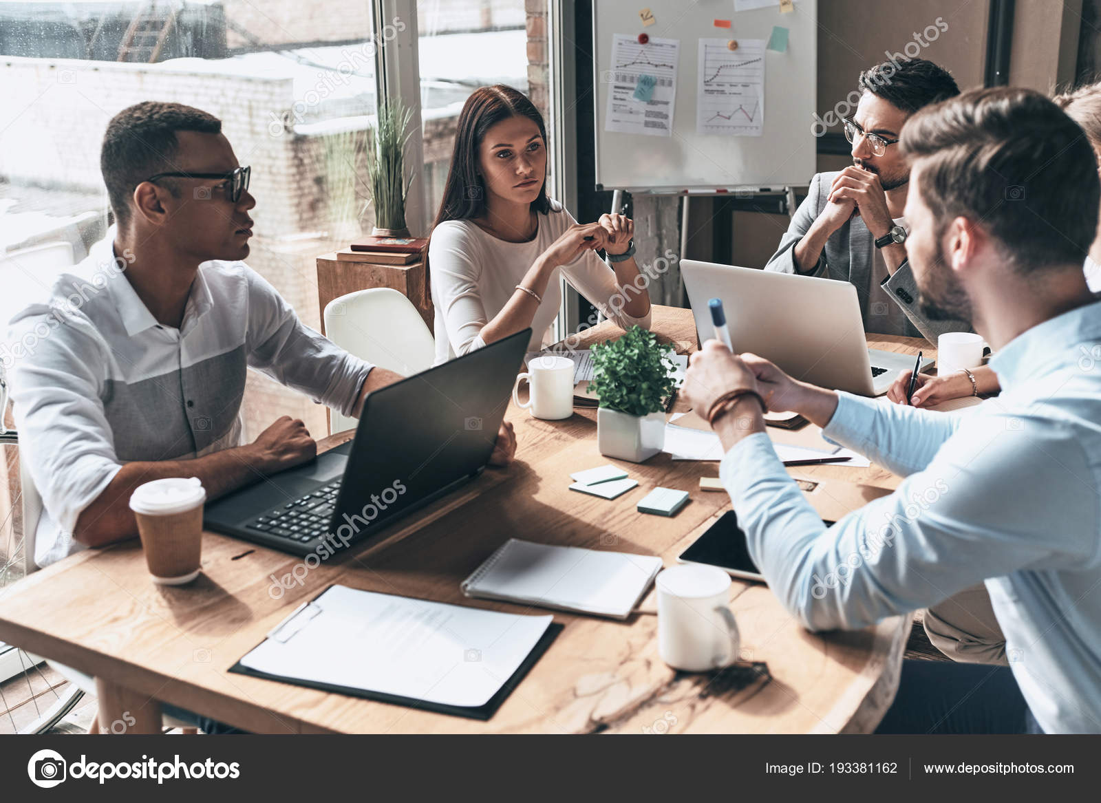 Young Business People Brainstorming Office Table Laptops Stock Photo by  ©gstockstudio 193381162