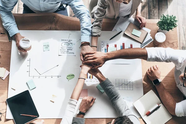 Top View Business Team Holding Hands Together Table Blueprint — Stock Photo, Image