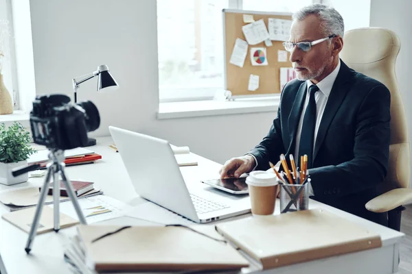 Senior man in elegant business suit using modern technologies while making social media video — Stock Photo, Image