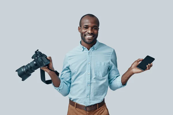 Happy Young African Man Using Digital Camera Smiling While Standing — Stock Photo, Image