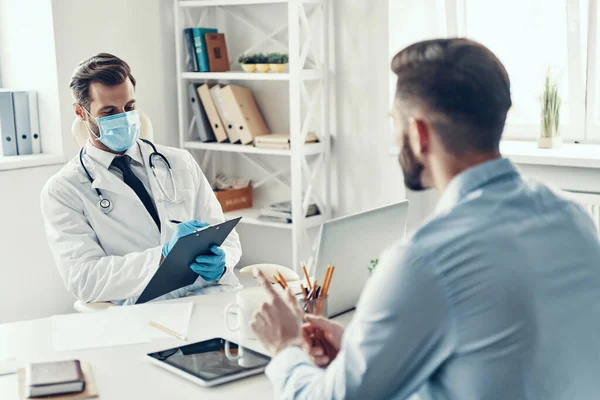 Young Doctor White Lab Writing Something Talking His Patient While — Stock Photo, Image