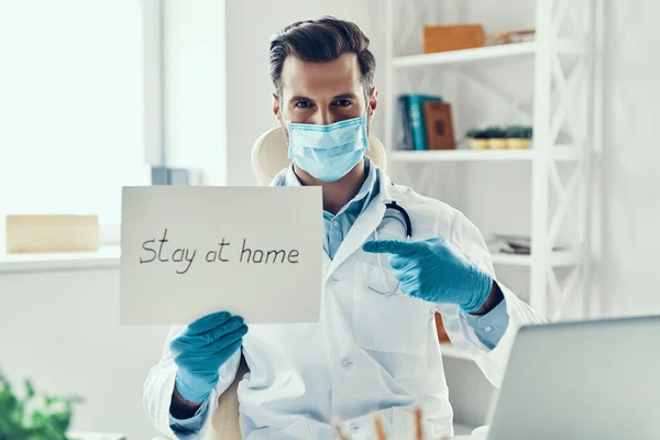 Young Man White Lab Coat Protective Mask Showing Stay Home — Stock Photo, Image