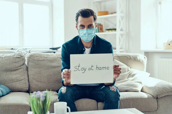 Young Man Protective Face Mask Showing Stay Home Saying Written — Stock Photo, Image