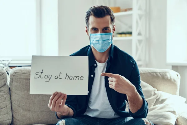 Handsome Young Man Protective Face Mask Showing Stay Home Saying — Stock Photo, Image