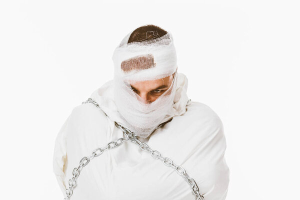 Injured man in straitjacket and chains 