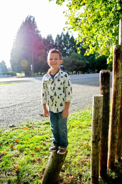 Young Boy Standing On Post — Stock Photo, Image