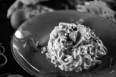 Lezzetli carbonara makarnası, taze malzemeler ve kızarmış pastırma.