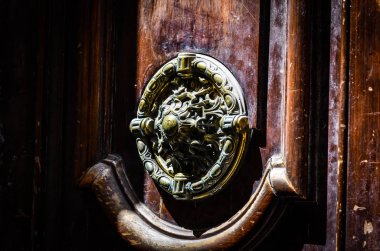 old doors close up view - knobs, design elements, architecture of the ancient doors within the streets of the spanish cities