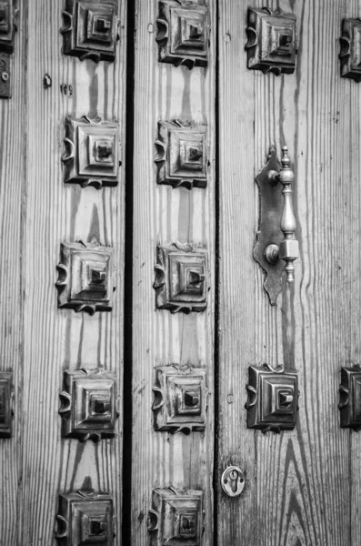 old doors close up view - knobs, design elements, architecture of the ancient doors within the streets of the spanish cities