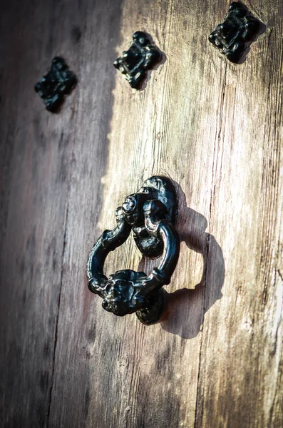 old doors close up view - knobs, design elements, architecture of the ancient doors within the streets of the spanish cities