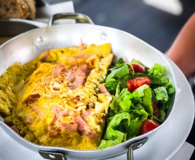 tasty breakfast omlette with fresh eggs, ham, mushrooms & cheese