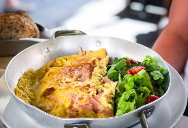 tasty breakfast omlette with fresh eggs, ham, mushrooms & cheese