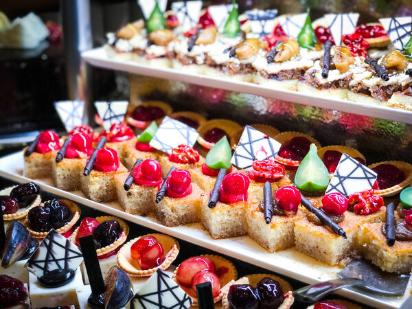 mix mini cakes & sweets with  fresh fruits & glazed topping