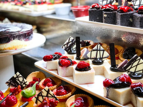 mix mini cakes & sweets with  fresh fruits & glazed topping