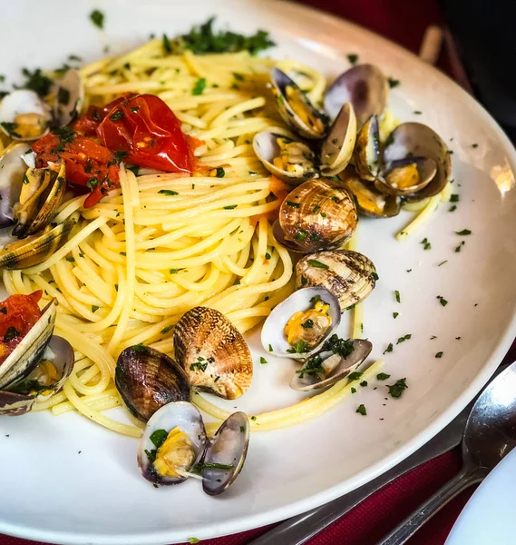 fresh seafood pasta with vongole, mix seafood, fresh vegetables, garlic, parsley & spices