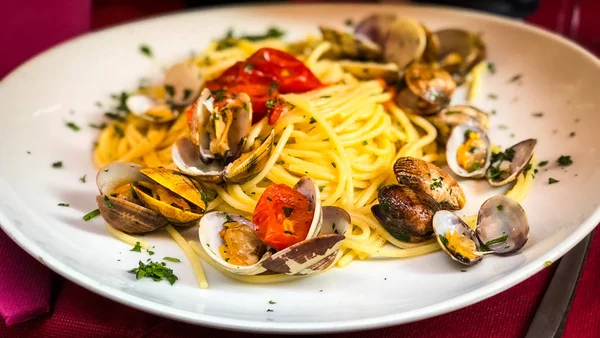 fresh seafood pasta with vongole, mix seafood, fresh vegetables, garlic, parsley & spices