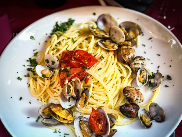 fresh seafood pasta with vongole, mix seafood, fresh vegetables, garlic, parsley & spices