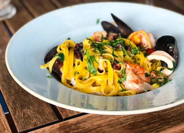 fresh seafood pasta with vongole, mix seafood, fresh vegetables, garlic, parsley & spices